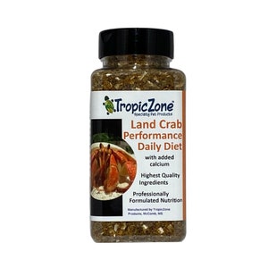 May include: A clear plastic jar filled with brown and beige land crab food. The label reads "Tropic Zone Specialty Pet Products Land Crab Performance Daily Diet with added calcium Highest Quality Ingredients Professionally Formulated Nutrition Manufactured by TropicZone Products, McComb, MS".