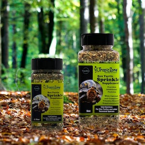 May include: Two bottles of TropicZone Box Turtle Sprinkle Supplement. The larger bottle is 5 oz and the smaller bottle is 2.75 oz. Both bottles contain a green, brown, and white mixture. The bottles have a black lid and a label with a turtle graphic and the product name.