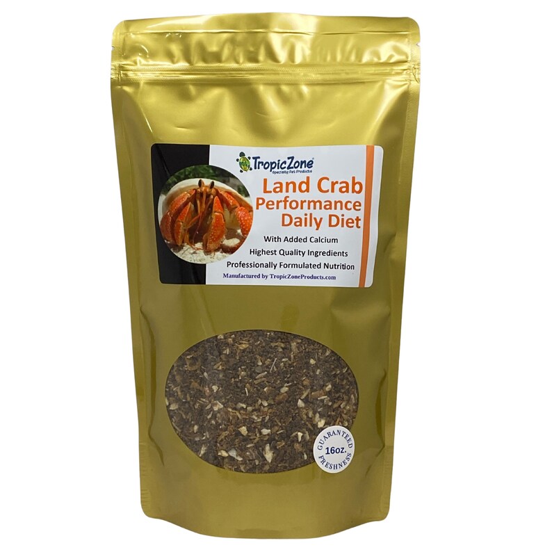 May include: A gold bag of Tropic Zone Land Crab Performance Daily Diet pet food with a picture of a land crab on the front. The bag is labeled with the text "With Added Calcium, Highest Quality Ingredients, Professionally Formulated Nutrition, Manufactured by TropicZoneProducts.com". The bag also has a label that says "Guaranteed Freshness 16oz".