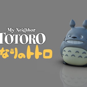 May include: A gray and yellow cartoon character with a big smile and large ears. The character is named Totoro and is from the movie "My Neighbor Totoro". The text "My Neighbor Totoro" and "となりのトトロ" is written in white and yellow letters on a gray background.