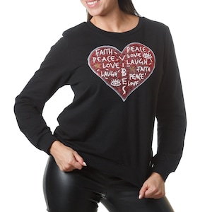 May include: Black long-sleeved sweatshirt with a red glitter heart design. The heart has the words "Faith, Peace, Love, Laugh, Believe, Peace" written inside.