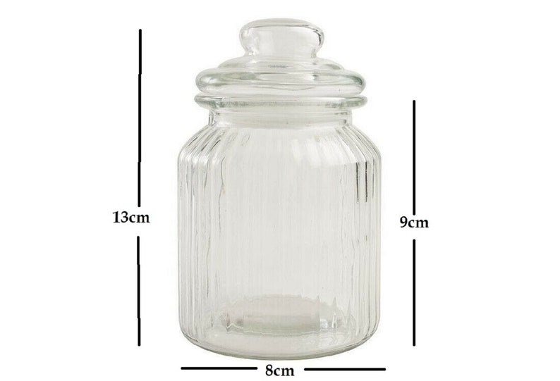 May include: Clear glass jar with a lid, 13 inches tall, 9 inches wide, and 8 inches in diameter. The jar has vertical ridges.
