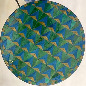 May include: A round table top with a geometric mosaic tile design. The tiles are blue, green, and gold. The table top is approximately 30 inches in diameter.