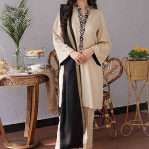 May include: A beige two-piece outfit with black accents. The long-sleeved top features a decorative neckline and black trim. A black scarf is draped over the shoulder. The outfit is paired with matching pants and black shoes. The outfit is suitable for formal occasions.