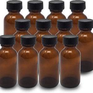 May include: Ten amber glass bottles with black screw-on caps. The bottles are all the same size and shape, and they are arranged in a staggered pattern.
