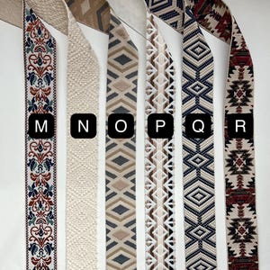 May include: Six different patterned fabric trims in various colors, including beige, brown, gray, white, blue, and red. The trims are labeled with the letters M, N, O, P, Q, and R.