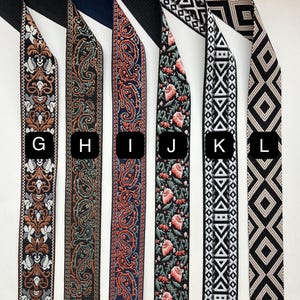 May include: Eight different patterned ribbon trims in various colors, including black, white, red, green, and gold. The trims are labeled with letters G through L.