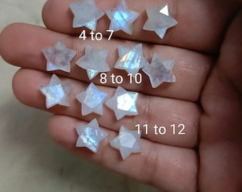 May include: Twelve iridescent rainbow moonstone star-shaped cabochons of varying sizes. The stars are labeled with numbers 1 to 12.