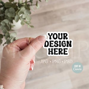 May include: A white sticker with black text that says "YOUR DESIGN HERE" and "JPG. PNG. PSD" below. The sticker is being held by a hand.