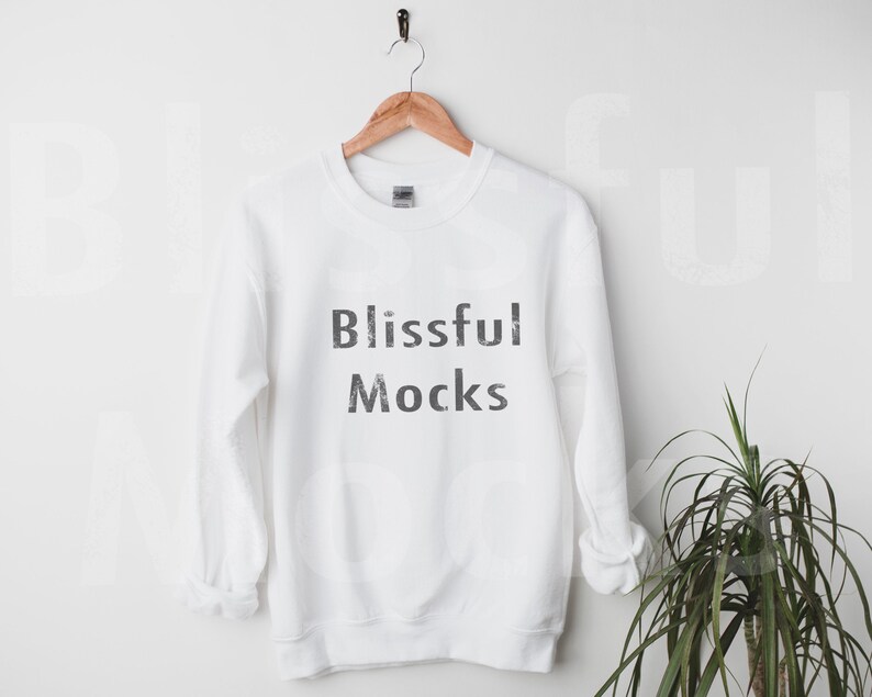 May include: White crewneck sweatshirt with the text "Blissful Mocks" printed in black on the front.