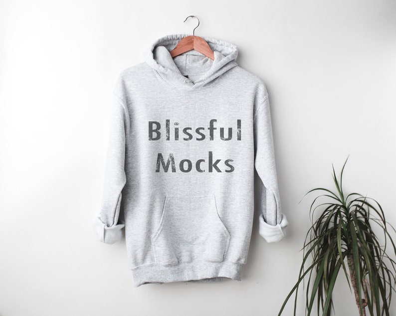 May include: A gray hooded sweatshirt with the text "Blissful Mocks" printed on the front.