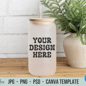 May include: A clear, frosted tumbler with a bamboo lid and straw. The tumbler has the text "YOUR DESIGN HERE" in black, retro-style lettering.