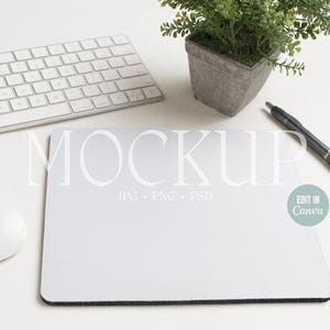 May include: A white mouse, a white keyboard, a gray pen, a potted plant, and a white mousepad with the text "MOCKUP JPG - PNG - PSD" and a green circle with the text "EDIT IN Canva".