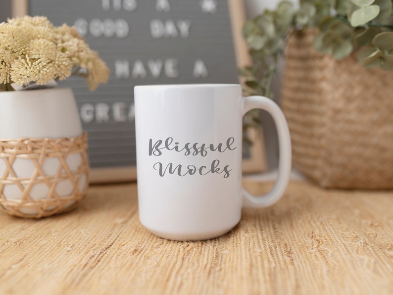 May include: White ceramic mug with a black handle. The mug has the text "blissful mocks" written on it in a cursive font.