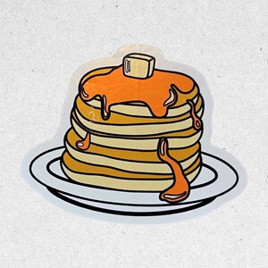 May include: A sticker depicting a stack of pancakes, drizzled with syrup and topped with butter. The pancakes are light brown, with orange syrup cascading down. The sticker is on a white plate with a black outline.