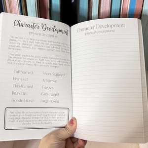 May include: Open notebook with lined pages and the title "Character Development (physical descriptions)" written at the top. The left page has a list of physical descriptions for characters, such as "Tall-framed", "Heavyset", "Thin-framed", "Brunette", and "Blonde/blond". The right page is blank.