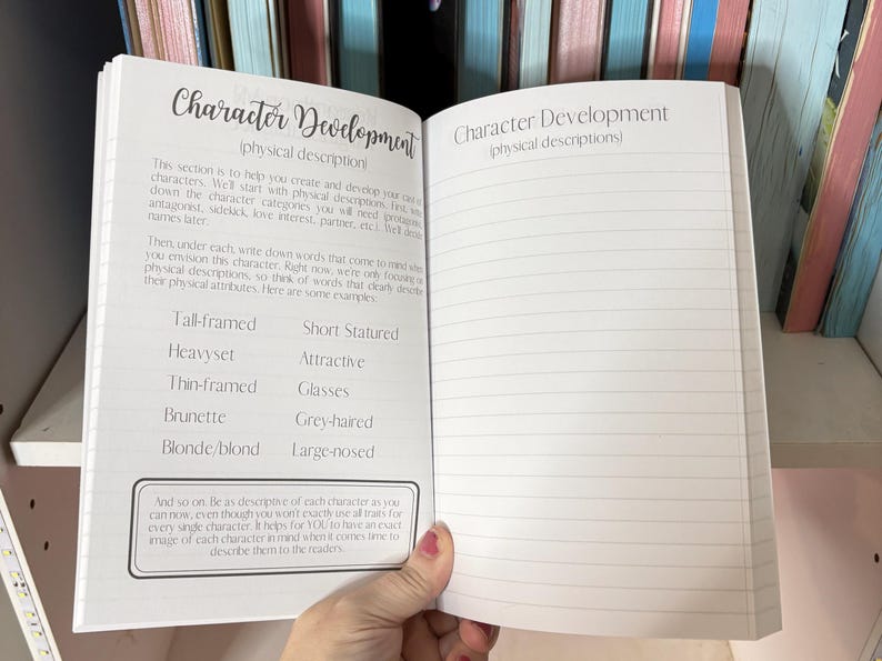 May include: Open notebook with lined pages and the title "Character Development (physical descriptions)" written at the top. The left page has a list of physical descriptions for characters, such as "Tall-framed", "Heavyset", "Thin-framed", "Brunette", and "Blonde/blond". The right page is blank.