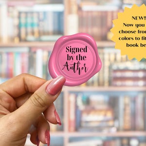 May include: A pink wax seal with the text "Signed by the Author" in black script. A yellow starburst graphic states "NEW!! Now you can choose from 30+ colors to fit your book best!"