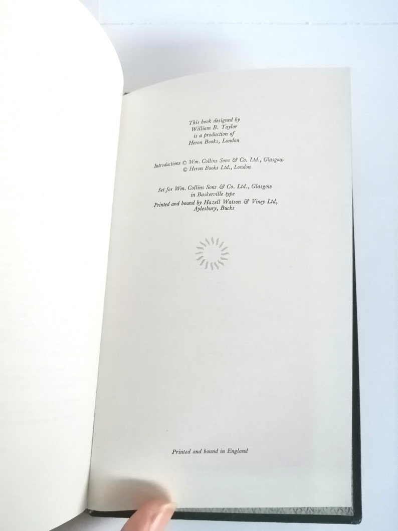 May include: A book with a white cover and black text. The text reads "This book designed by William B. Taylor is a production of Heron Books, London." The text also includes copyright information for the book.