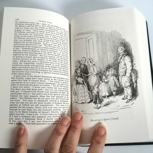 May include: A black and white illustration of a group of people standing in a doorway. The people are dressed in 19th-century clothing. The text "The arrival at Queen's Crawley" is printed below the illustration.