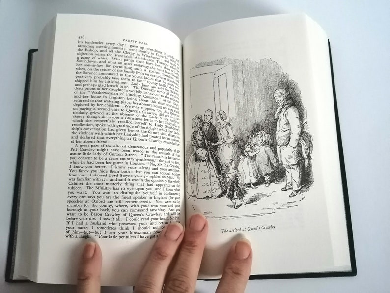 May include: A black and white illustration of a group of people standing in a doorway. The people are dressed in 19th-century clothing. The text "The arrival at Queen's Crawley" is printed below the illustration.