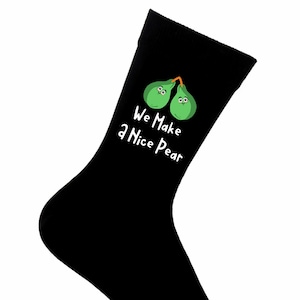 May include: Black socks with a green pear design and the text "We Make a Nice Pear".