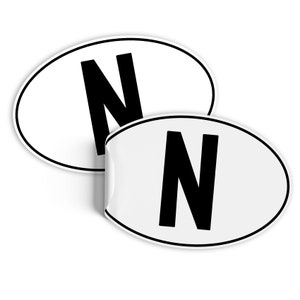 May include: Two white oval stickers with a black letter N printed on each.
