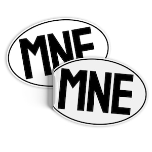 May include: Two white oval stickers with black text. The top sticker says "MNF" and the bottom sticker says "MNE".
