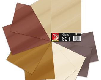 Könnte beinhalten: Eine Packung mit 10 Premium-A4-Blättern in verschiedenen Farben, darunter Braun, Beige, Gold und Grau. Die Packung ist mit "Glanz 621" gekennzeichnet.