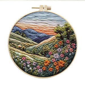 May include: Embroidered hoop art depicting a landscape with mountains, hills, and a field of flowers in shades of green, blue, orange, and pink.