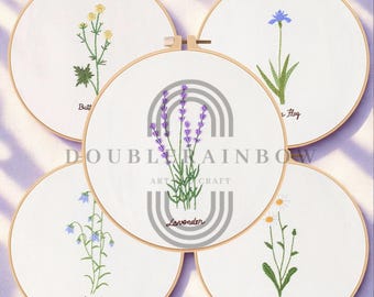 May include: Five embroidered floral designs on white fabric stretched within wooden hoops. The designs include a buttercup, lavender, a blue flower, a bluebell, and a daisy. The text "DOUBLE RAINBOW ART CRAFT" is also visible.