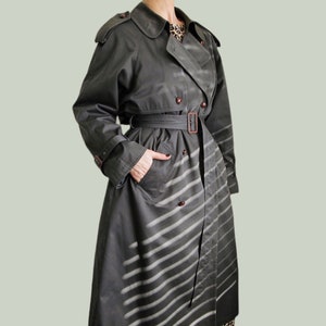 Model wearing vintage 1999s Dark grey belted trench coat