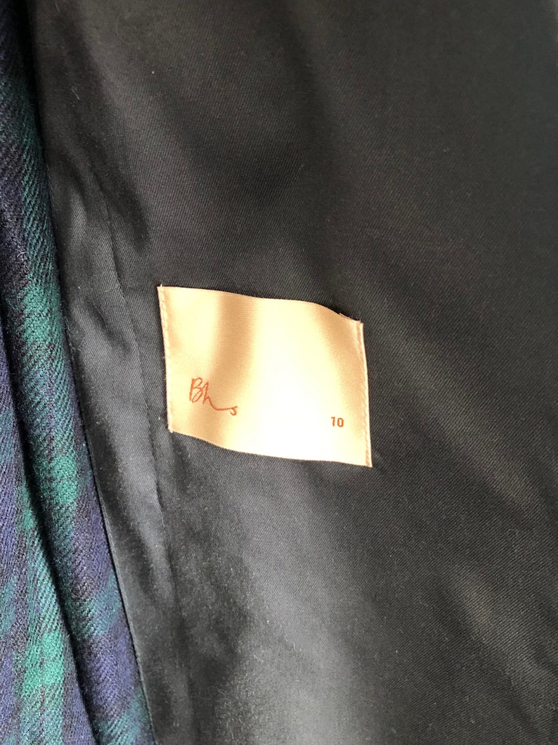 May include: A beige fabric label with the text "Bhs" and the number "10" printed in brown.