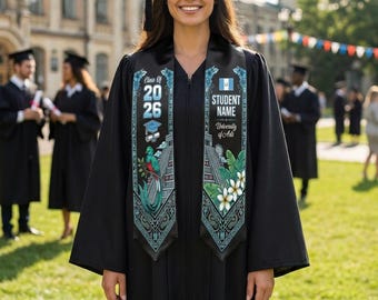 May include: A black graduation gown and cap with a custom stole featuring the text Class Of 26, Student Name, and University of Arts. The stole displays a quetzal bird, Mayan pyramid architecture, tropical leaves, white flowers, and a Guatemala flag.