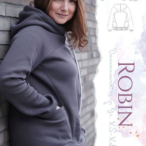 May include: A gray hooded sweatshirt with a pocket on the side. The sweatshirt has a long, asymmetrical hemline. The image also shows a line drawing of a hooded sweatshirt with a geometric design.