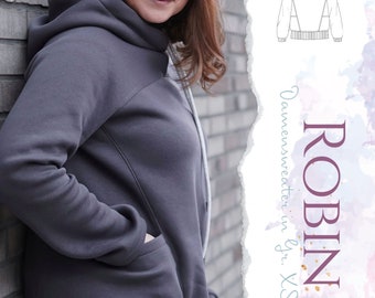 Puede incluir: Una sudadera gris con capucha y un bolsillo en el lateral. La sudadera tiene un dobladillo largo y asimétrico. La imagen también muestra un dibujo de línea de una sudadera con capucha con un diseño geométrico.