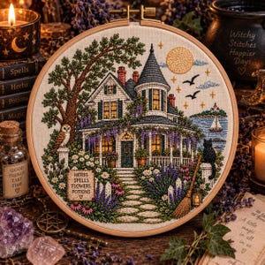 May include: A circular embroidery hoop featuring a detailed stitched scene of a Victorian house with a turret, surrounded by purple wisteria, a stone path, an owl, a black cat, and a sign reading HERBS SPELLS FLOWERS POTIONS under a full moon.