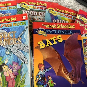 May include: A collection of colorful children's books featuring the Magic School Bus series. The books cover topics like insects, food chains, colors, bats, and germs. Each book has a bright, eye-catching cover with illustrations and text.