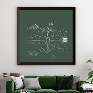 May include: A framed print of a minimalist line drawing of a mountain range reflected in a lake. The drawing is in white on a dark green background.