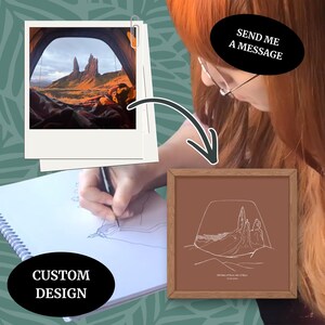 May include: A framed print with a brown background and a white line drawing of a mountain landscape. A polaroid photo of the same landscape is attached. The text "CUSTOM DESIGN" is visible. The text "SEND ME A MESSAGE" is also visible.