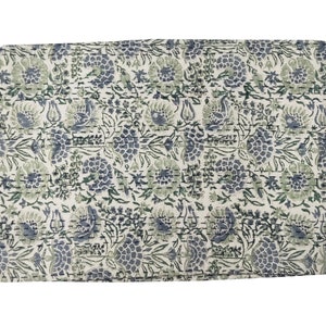 May include: A white kantha quilt with a floral pattern in shades of blue and green. The quilt is made of cotton and has a hand-stitched design.