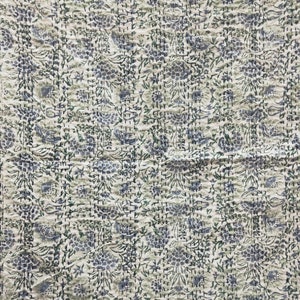 May include: A white cotton kantha quilt with a blue and green floral pattern. The quilt is hand-stitched and has a textured surface.