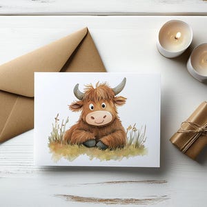 May include: A watercolor illustration of a brown Highland cow with a white face, sitting on a bed of green grass. The cow has large, brown eyes and a friendly expression.