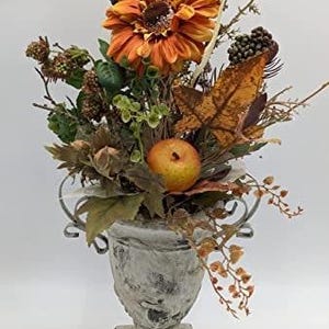 Autumn arrangement autumn decoration apple orange raspberry gerbera leaves grasses orange green