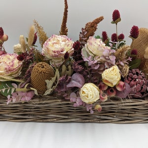 Fall arrangement of rose thistle berries purple