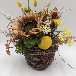Summer arrangement lemon sunflower foliage berries grasses orange