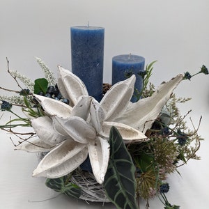 Winter arrangement candle heather accessories berries grasses blue