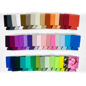 May include: A variety pack of 30 neoprene can coolers in a variety of colors and patterns, including solid colors, camouflage, and floral prints.