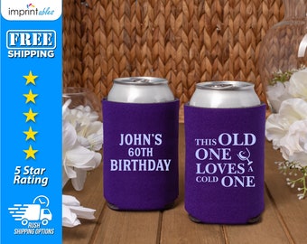 May include: Two purple can coolers with white text. One cooler says "John's 60th Birthday" and the other says "This Old One Loves a Cold One".