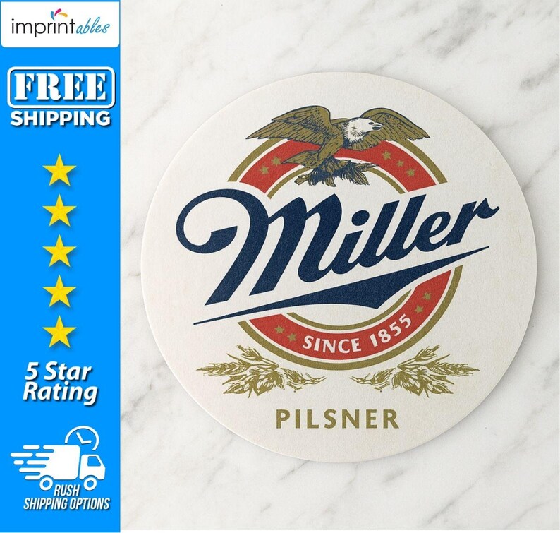 May include: A round, off-white coaster with the Miller logo. The logo features a navy blue script wordmark, a red and gold circular emblem with an eagle, and the text "SINCE 1855". The word "PILSNER" is printed at the bottom.